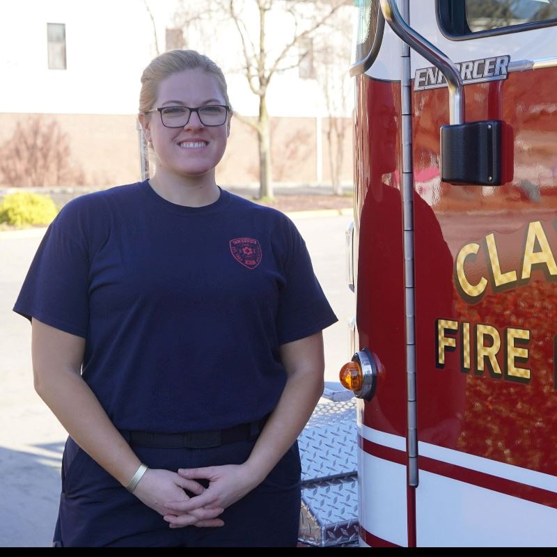 Firefighter Rena Smith Seitz standing next to a Clayton Fire Department truck