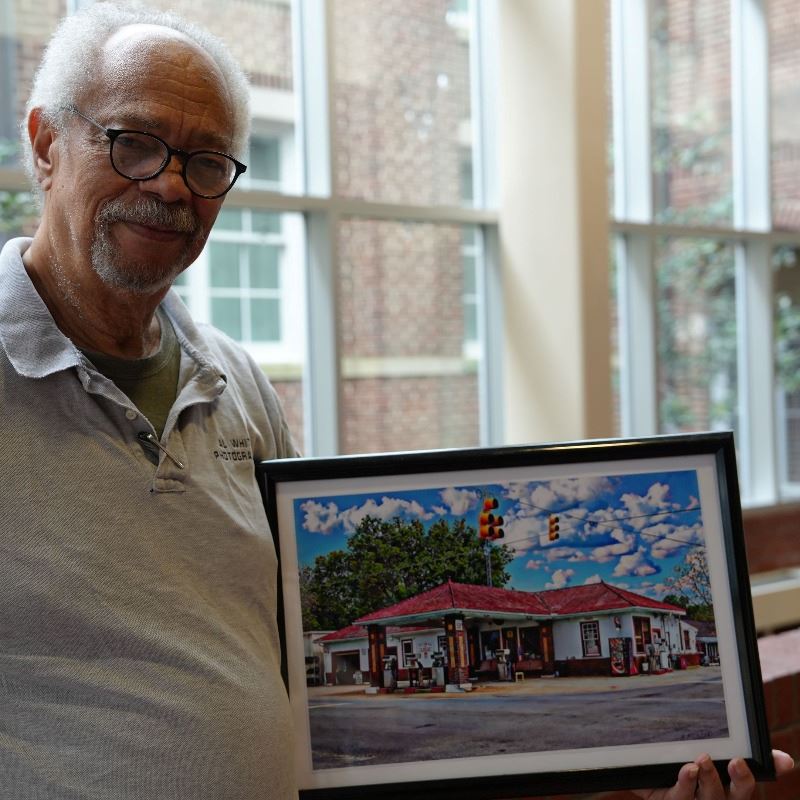 Local Artist Al White Holds His Winning Picture in the 2024 Capturing Clayton Photography Contest