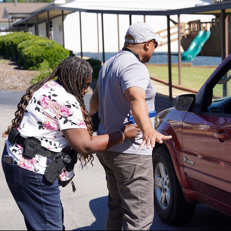 Participant takes part in role-playing scenario, arresting Clayton police officer