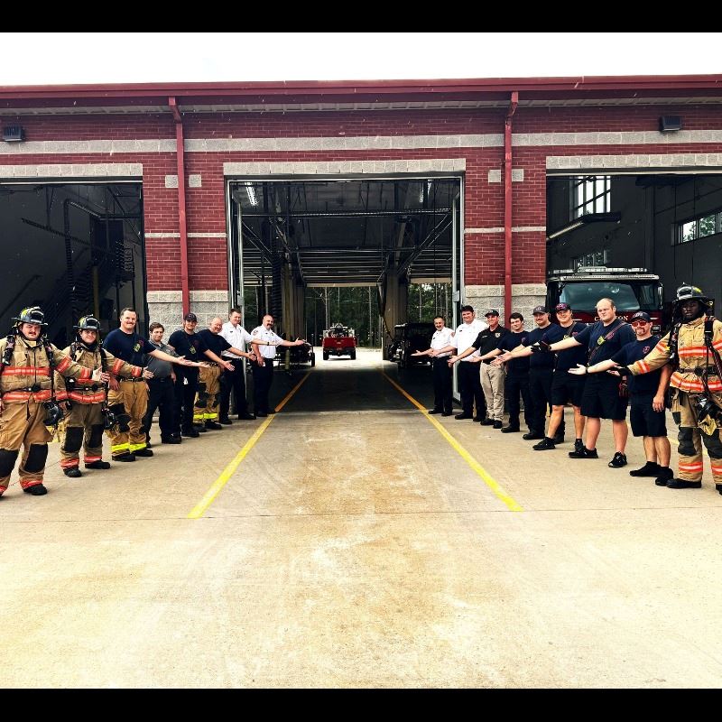 Employees of the Clayton Fire Department stand outside the garage of Clayton Fire Station 1 