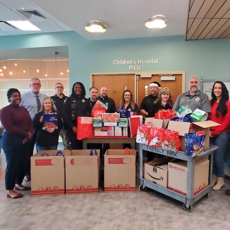 Members of Clayton Police Department staff deliver gives to local children's hospital