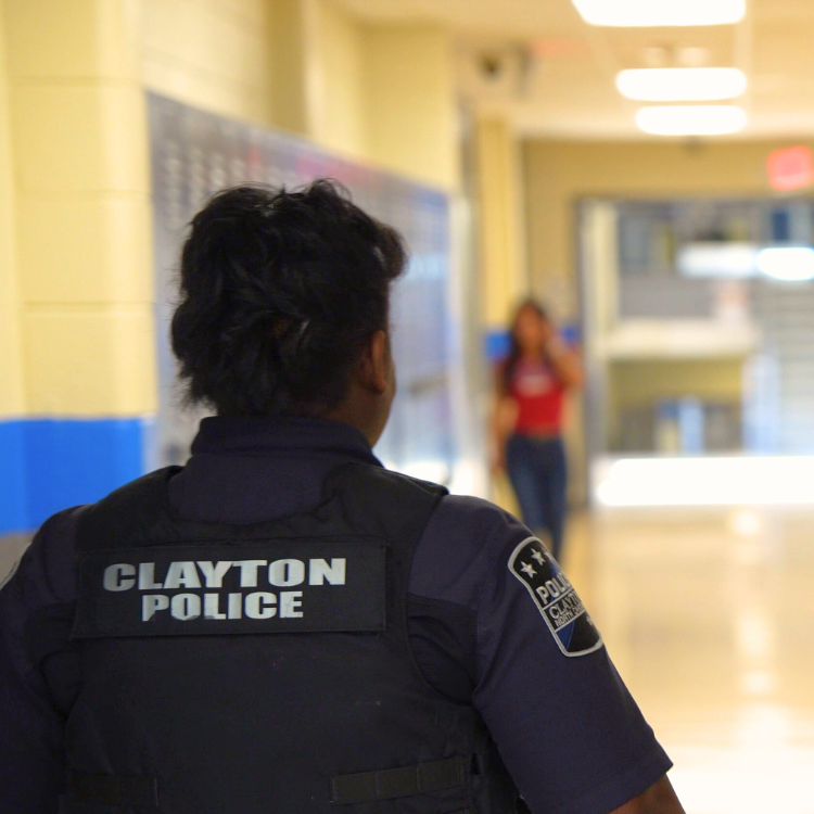 Clayton School Resource Officer patroling hallway in local school