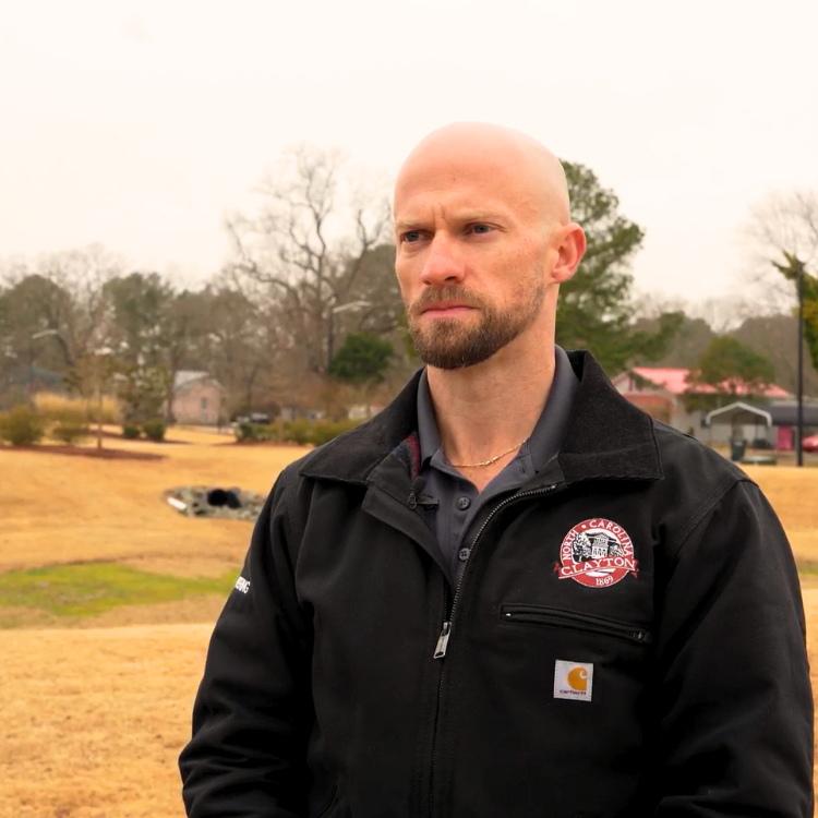 Joshua Cotten in front of stormwater drainage