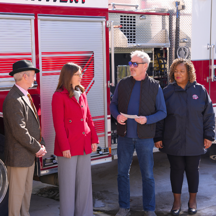 Mayor Jody McLeod, Council Members Gretchen Williams and Andrea Archer stand in front of firetruck 