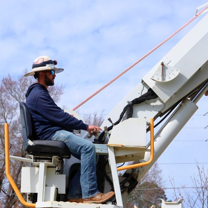 Lineman operates utility truck