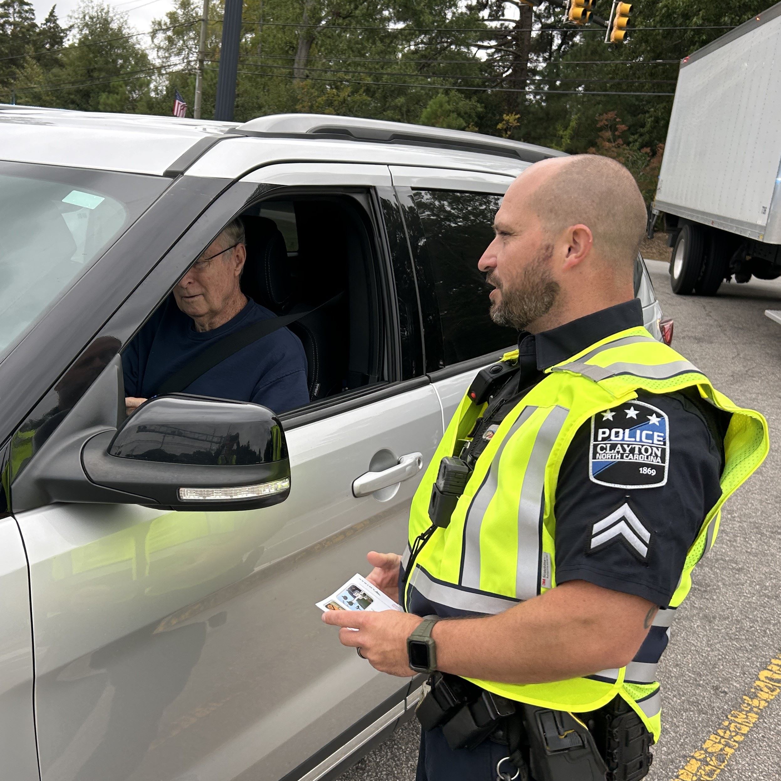Clayton Police Officer talks to motorist about rail safety